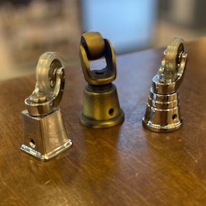 May include: Three furniture caster wheels with different finishes. One is silver, one is gold, and one is chrome. Each caster has a clear plastic wheel.