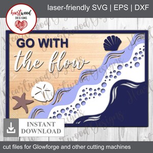 May include: A wooden sign with the text "GO WITH the flow" in white lettering. The background is a light wood color with a blue and white wave design. The wave design includes a seashell, a starfish, and a sand dollar.