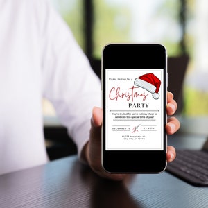 May include: A smartphone displaying a Christmas party invitation with a red Santa hat graphic. The invitation text reads "Please join us for a Christmas Party. You're invited for some holiday cheer to celebrate this special time of year! December 25, 2-4 PM, At 123 anywhere st, any city, st 12345."