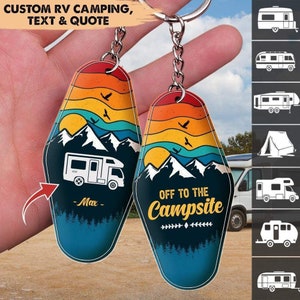 May include: Two colorful keychains with a retro motel design. One keychain features a mountain scene with a white RV and the text "Max". The other keychain features a mountain scene with the text "Off to the Campsite".