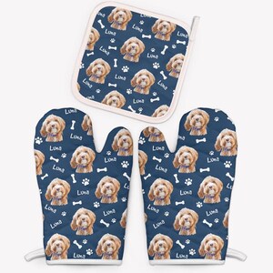 May include: A set of two blue oven gloves and a matching pot holder with a white border. The gloves and pot holder feature a repeating pattern of a dog's face with the name "Luna" printed on each item.