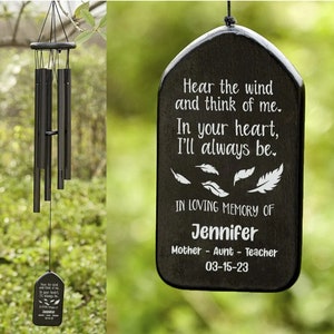 May include: Black wind chime with a wooden plaque that reads "Hear the wind and think of me. In your heart, I'll always be."  The plaque also says "In loving memory of Jennifer Mother - Aunt - Teacher 03-15-23".