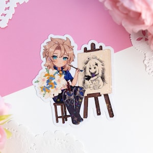May include: A sticker featuring a cartoon character with blonde hair and blue eyes, holding a paintbrush and a bouquet of flowers. The character is seated and painting on a small easel. The artwork on the easel depicts a cartoon character. The sticker has a white border.