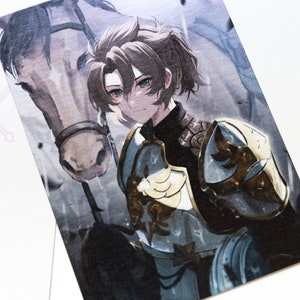 May include: Illustration of a knight with blue eyes, wearing ornate armor with gold accents, and holding a lance. A horse is partially visible behind the knight. The artwork has a watercolor style and a fantasy theme.