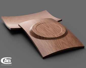 May include: Two wooden trays with a curved shape. The top tray has a circular indentation in the centre. The trays are made of a light brown wood with a visible grain pattern.