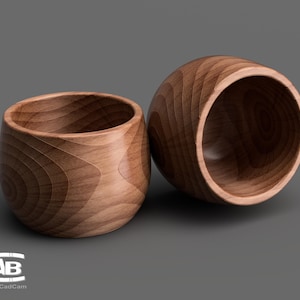 May include: Two wooden bowls, one larger than the other, with a natural wood grain finish. The bowls are empty and have a smooth, rounded shape.