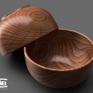 May include: Two wooden bowls, one nested inside the other, with a natural wood grain pattern. The bowls are made of light brown wood and have a smooth, polished finish.