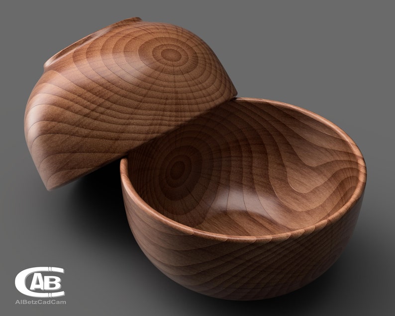 May include: Two wooden bowls, one nested inside the other, with a natural wood grain pattern. The bowls are made of light brown wood and have a smooth, polished finish.