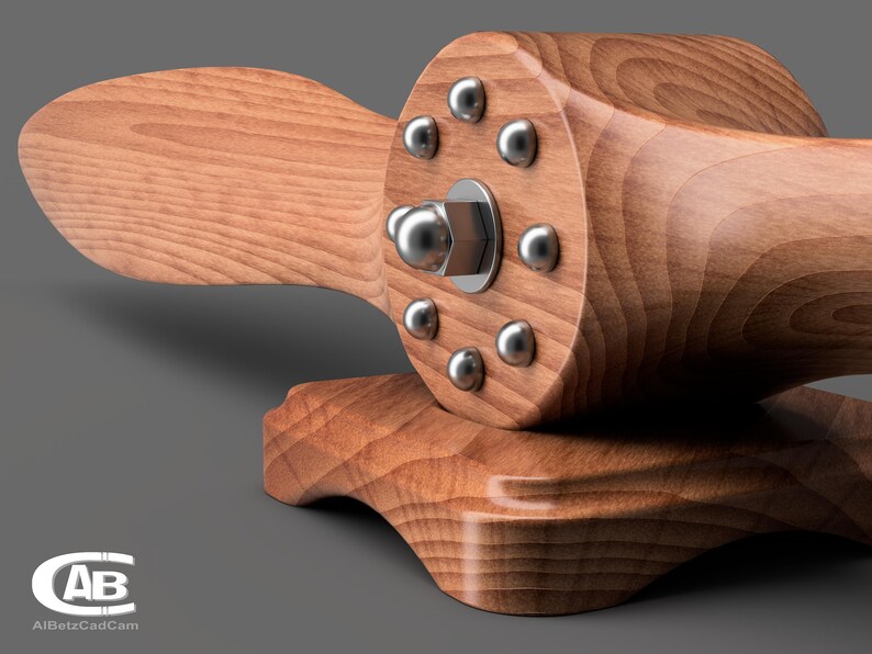May include: A wooden airplane propeller with a silver metal hub and eight silver metal screws. The propeller is mounted on a wooden base.