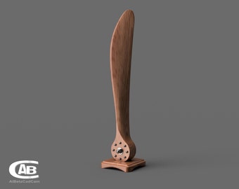 May include: A wooden propeller with a silver hub, mounted on a wooden base. The propeller is a dark brown color and has a smooth finish.