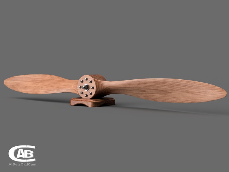 May include: A wooden airplane propeller with a metal hub and a wooden base. The propeller is mounted on the base and is ready to be displayed.