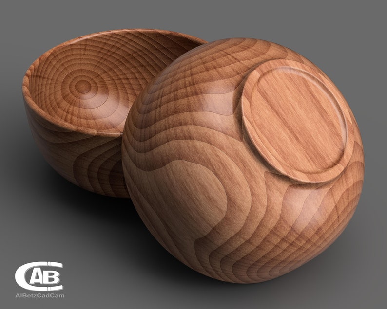 May include: Two wooden bowls, one turned upside down, showing the grain of the wood. The bowls are a light brown colour.