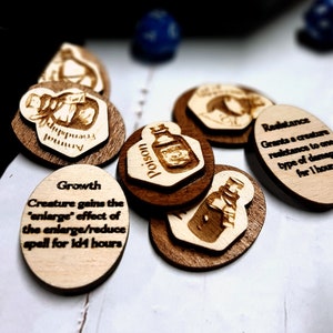 May include: Wooden tokens with engraved images and text. The tokens feature images of potion bottles and text such as "Growth", "Poison", and "Resistance".