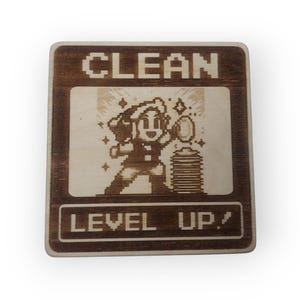 May include: A wooden sign with a pixelated image of a person holding a cleaning tool and stars. The sign says "CLEAN LEVEL UP!" in a pixelated font.