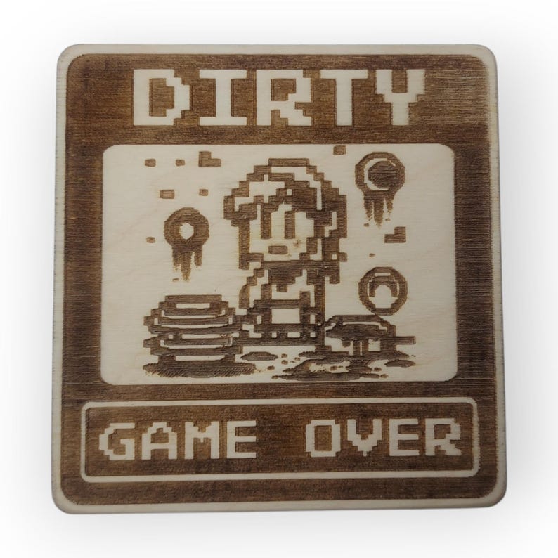May include: A wooden sign with the text "DIRTY GAME OVER" in a pixelated font. The sign features a pixelated image of a character in a video game, surrounded by pixelated objects.