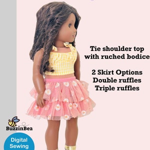 May include: A digital sewing pattern for a doll outfit. The outfit includes a yellow and white gingham tie-shoulder top with a ruched bodice and a pink tulle skirt with white daisy accents. The skirt has two options: double ruffles or triple ruffles. The pattern is called "Heather Top & Skirt".
