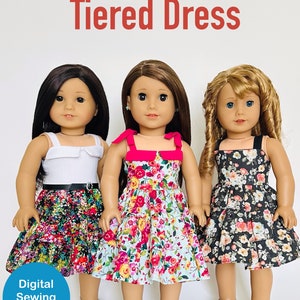 May include: Three 18 inch dolls wearing tiered dresses. The dolls are wearing floral print dresses. The dress on the left is black with pink and white flowers. The dress in the middle is light blue with pink and yellow flowers. The dress on the right is black with white and pink flowers. The text "Designed to fit 18" Dolls" and "BuzzinBea Tiered Dress" is at the top of the image. The text "Digital Sewing Pattern" is at the bottom of the image.