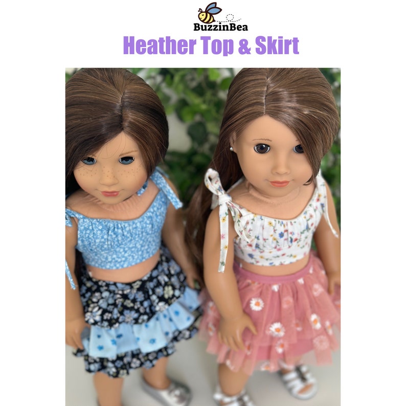 May include: Two dolls wearing matching outfits. The doll on the left is wearing a blue floral print top and a black and blue tiered skirt. The doll on the right is wearing a white floral print top and a pink tulle skirt with white daisies. The dolls are both wearing silver shoes. The image is titled "Heather Top & Skirt" with a bee logo above the title.