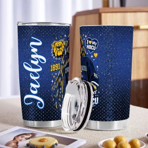 May include: A pair of stainless steel tumblers with a blue background and a design featuring the name "Jaelyn", a bulldog, and the text "I Love My HBCU". One tumbler has a lid removed.