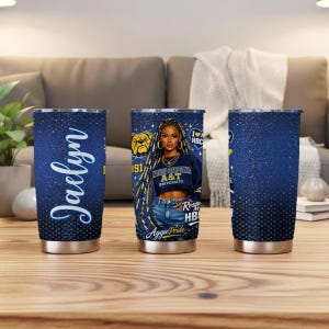 May include: Three stainless steel tumblers with a navy blue glitter design. One tumbler features the name "Jaelyn" in white script. The other two tumblers have a graphic of a woman wearing a North Carolina A&T University sweatshirt.