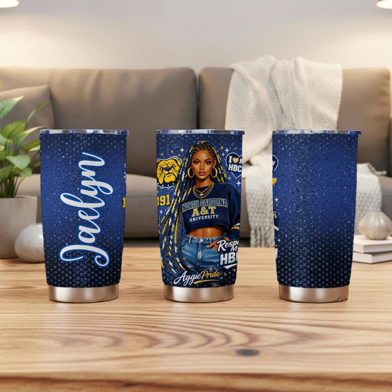 May include: Three stainless steel tumblers with a navy blue glitter design. One tumbler features the name "Jaelyn" in white script. The other two tumblers have a graphic of a woman wearing a North Carolina A&T University sweatshirt.