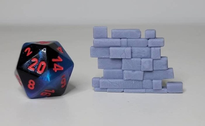 May include: A blue and black 20-sided die with red numbers and a light purple brick wall.