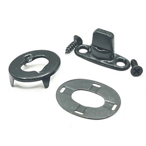 May include: A set of black metal snap fasteners with a black plastic stud. The set includes a base, a stud, a washer, and two screws.