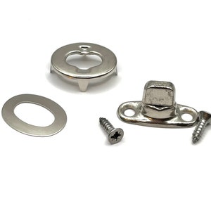 May include: A set of silver-toned metal snap fasteners with two screws. The fasteners are used for attaching fabric or other materials together.