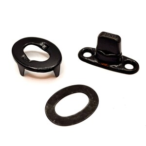 May include: A set of three black metal snap fasteners. The set includes a stud, a cap, and a washer. The stud has a small, raised knob on top. The cap has two small holes on either side. The washer is a flat, oval-shaped piece of metal.