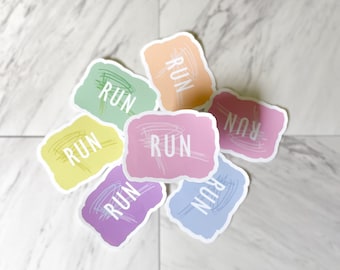 May include: A collection of colorful stickers with the word "RUN" in white, each with a unique pastel background and a scribbled design. The stickers are in shades of pink, purple, blue, yellow, green, and orange.