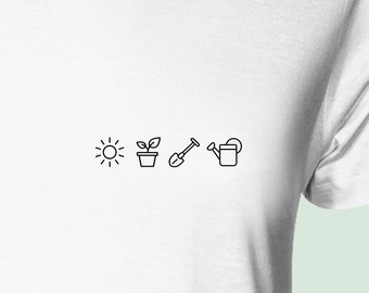 May include: A white t-shirt with a black line drawing of a sun, a potted plant, a shovel, and a watering can.