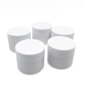 May include: Five white plastic containers with lids. The containers are round and have a smooth surface.