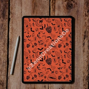 May include: A digital tablet with a black case displaying a Halloween-themed pattern on a bright orange background. The pattern includes bats, skulls, moons, hearts, and other spooky symbols.