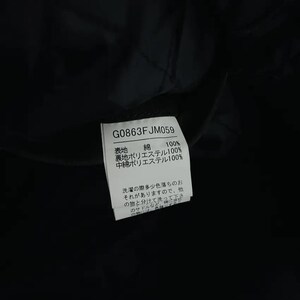 May include: A close-up of a black garment tag with the text "G0863FJM059". The tag lists fabric composition: 100% cotton, 100% polyester lining, and 100% polyester filling. Japanese text is also present.