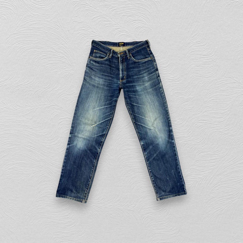May include: A pair of blue denim jeans with a faded wash and a straight leg fit.