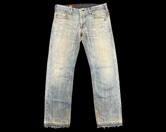 Talla 33x31. Jeans Levi's vintage negros, edición japonesa, mezclilla desgastada con cierre ajustable en la espalda y botón de estrella. Archivo de moda Y2K, Japón. Raro.