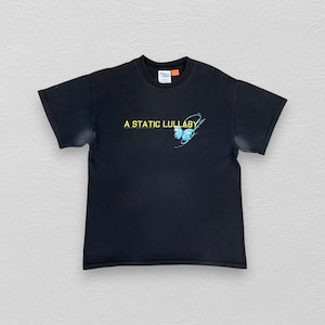 May include: Black t-shirt featuring the text "A STATIC LULLABY" in yellow, with a blue butterfly graphic. The shirt is a classic crew neck style.