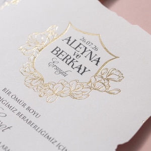 Delicate Gold Monogram, Soft Floral Details, Classic White Palette, Timeless Elegance, Wedding Invitation