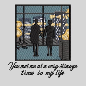 May include: Embroidered patch featuring a couple standing in a window overlooking a city skyline at night. The text "You met me at a very strange time in my life" is below the image.