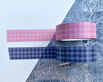May include: Two rolls of washi tape, one pink and white gingham pattern and one gray and white gingham pattern.
