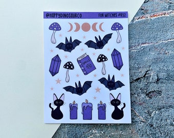 May include: A sheet of stickers with a witchy theme. The stickers feature bats, mushrooms, crystals, candles, a book that says "Spells", and black cats. The text at the top of the sheet says "@happy dinosourco for witches #032".