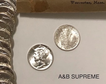 May include: Two silver US dimes, one with the profile of a woman and the year 1941, the other with the Statue of Liberty and the words "United States of America" and "One Dime".