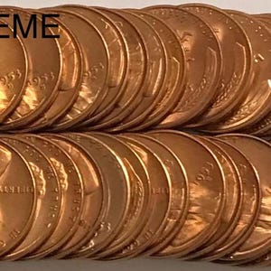 May include: A collection of copper pennies, arranged in two rows. The top row features the text "ONE CENT UNITED STATES OF AMERICA". The bottom row displays the profile of a man. The text "A & B SUPREME" is at the top.