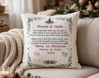 May include: A square off-white throw pillow featuring a Christmas-themed border of holly and pine. The text reads: Mummy & Daddy, I've only been with you for just a little while. I can't speak the words I Love You so I say them with my smile.