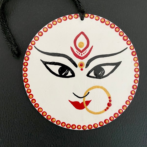 Goddess Durga face painting on round wooden plaque