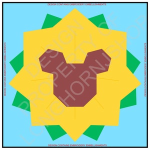 May include: A yellow flower with green petals and a brown bear face in the center. The text "DESIGN CONTAINS EMBROIDERY EMBELLISHMENTS" is written at the top and bottom of the image.