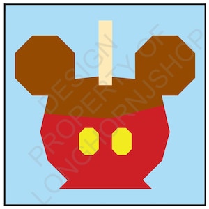 May include: A red and brown candy apple with Mickey Mouse ears and two yellow circles for eyes. The apple is on a stick.