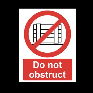 May include: A red and white sign with a red circle and a diagonal line through it. The circle contains a black line drawing of a pallet. The sign reads "Do not obstruct".