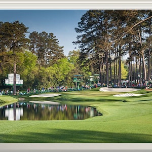 May include: A window view of a golf course with a pond and green grass. The course is surrounded by trees and there are people in the distance.