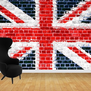 May include: A black wingback chair with a high back and three legs sits in front of a brick wall painted with the Union Jack flag. The wall is red, white, and blue. The floor is made of wood.